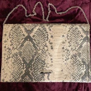 Jennifer Lopez Snake print clutch.